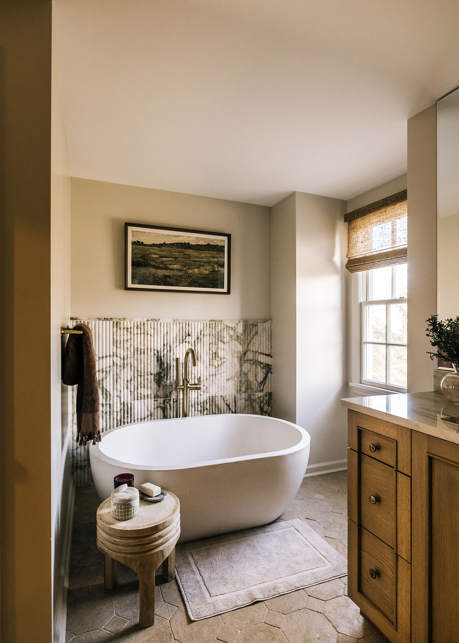 A Black Boot Builder bathroom renovation with a large tub and a framed photo overhead.