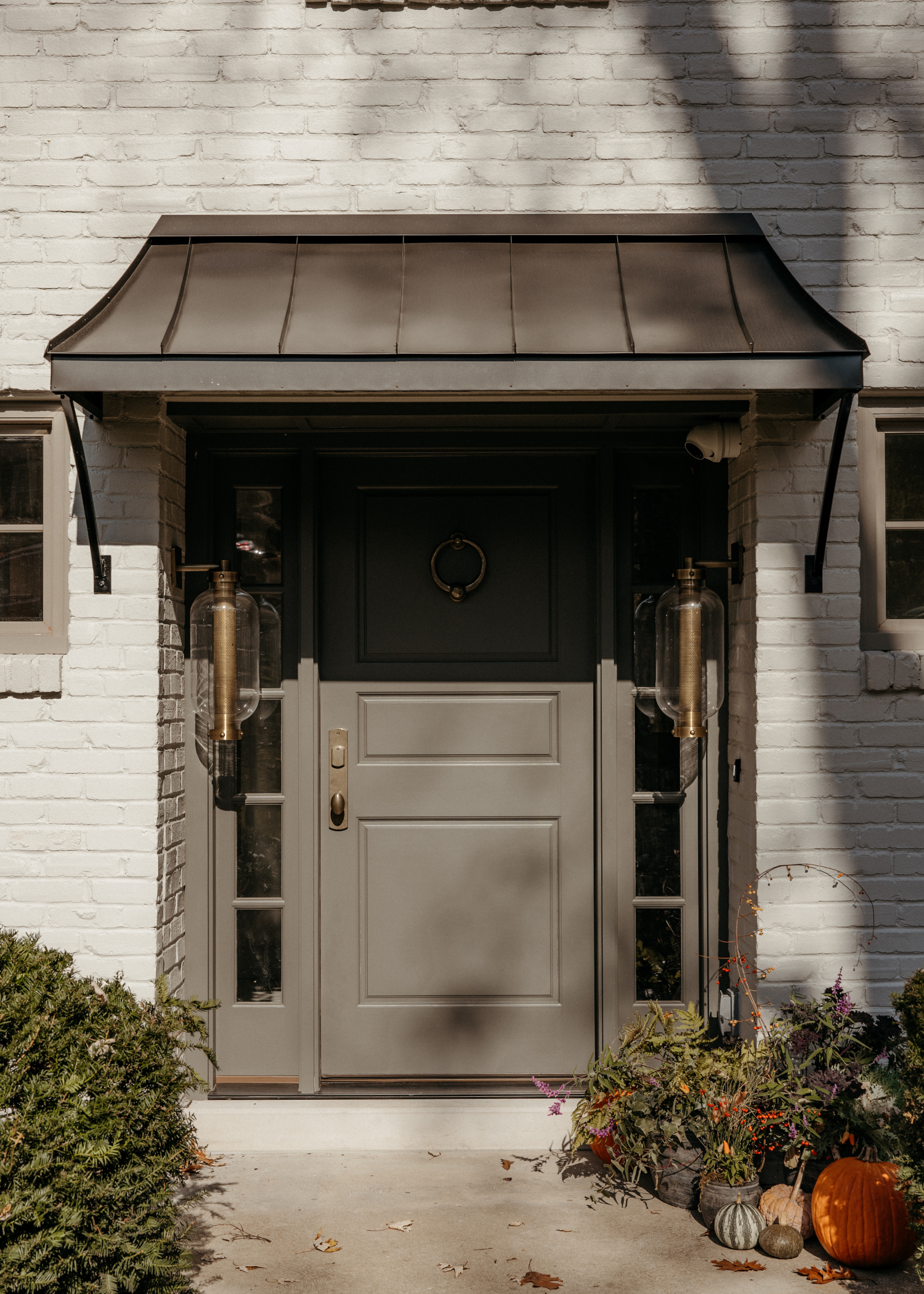 A front door of a custom home with an awning.