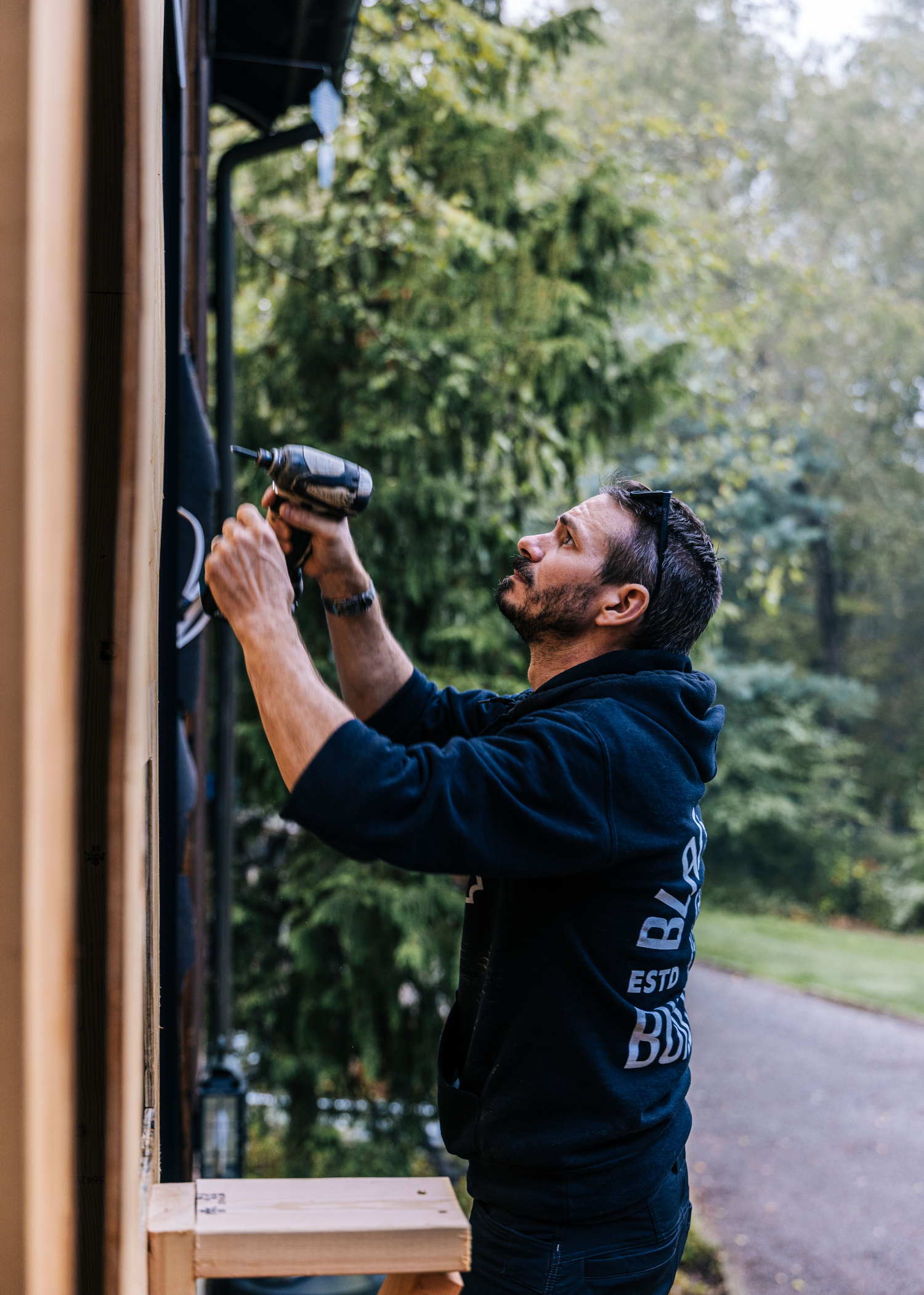 A Black Boot Builder working on a custom home.