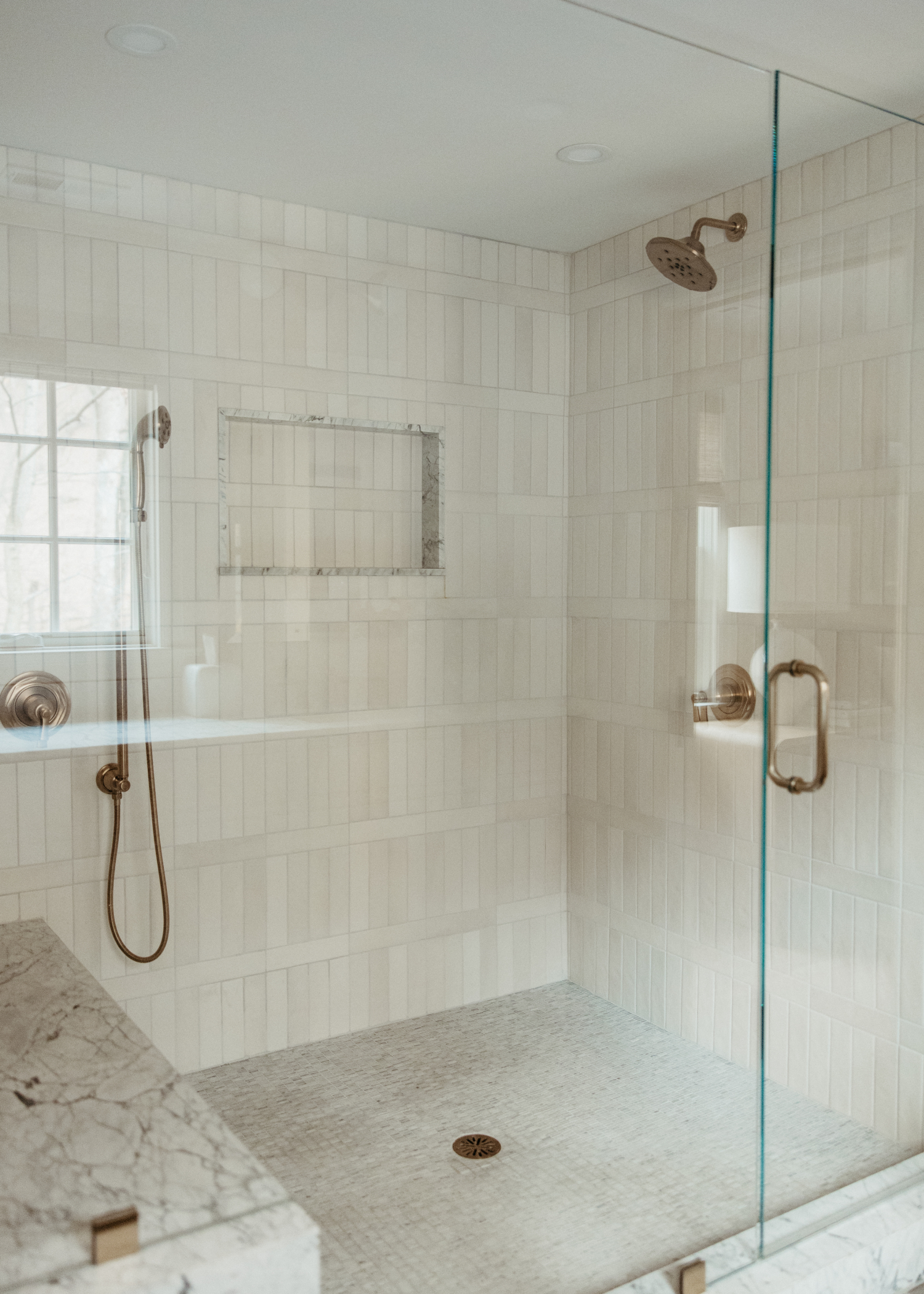 A custom designed shower with vertical tiles.